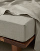 Ravello Fitted Sheet in Bone, European linen with extra thick banding detail, styled on wooden bed frame by Weave Home