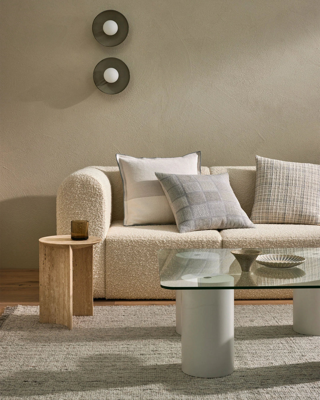 Neutral living room with beige sectional sofa styled with Riccardo and Bodrum cushions in cream, grey and natural tones, layered textures, and minimalist decor