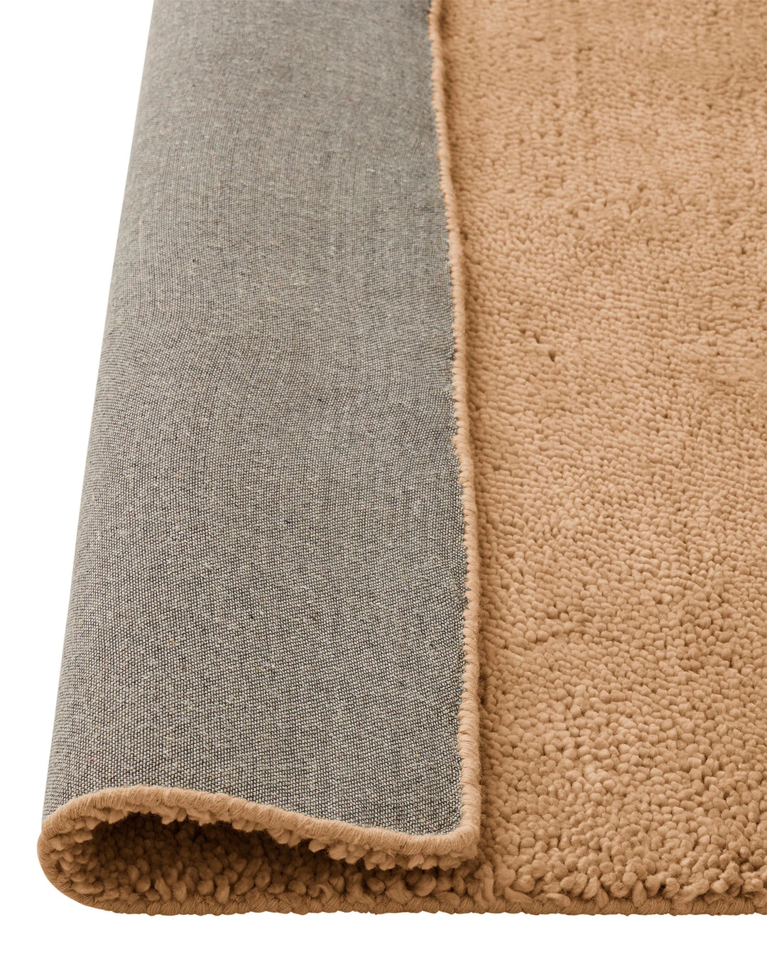 Valencia Camel rug detail, showing plush woven NZ wool pile with camel binding edge, by Weave Home