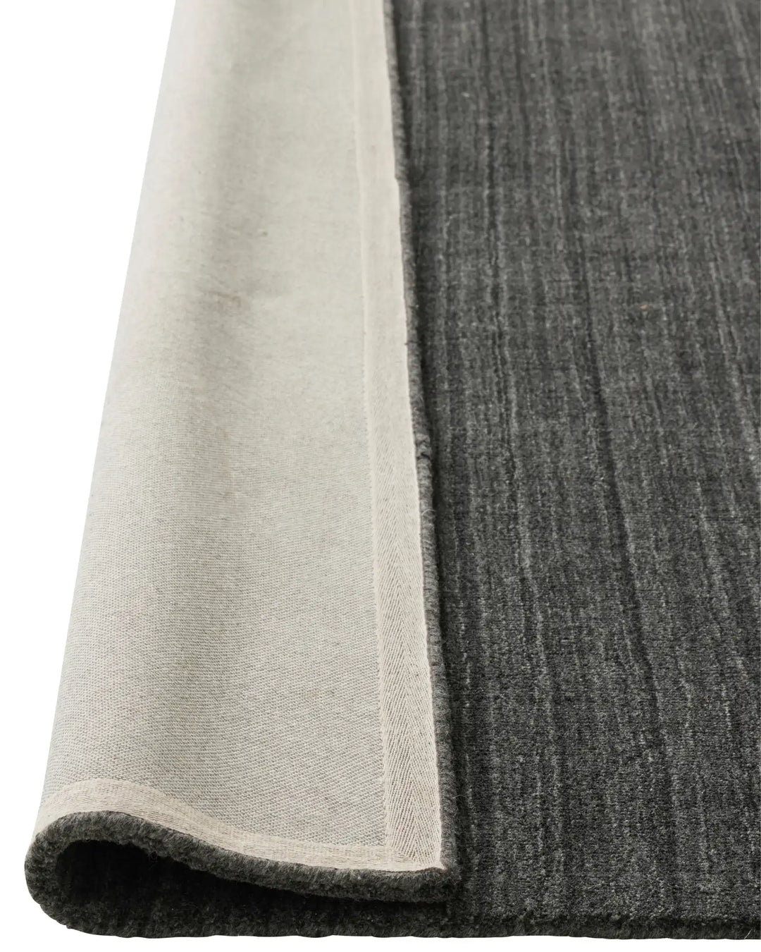 Gippsland Alloy rug corner detail showing charcoal viscose blend with cotton braided edge, 200x300cm by Weave Home