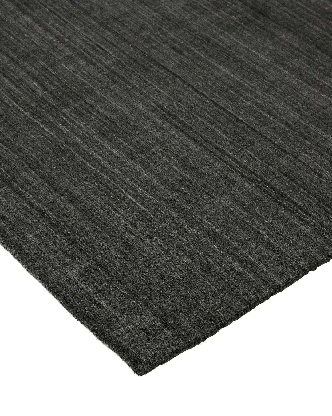 Gippsland Alloy rug corner detail, charcoal with grey-silver striped weave and cotton braided edge by Weave Home