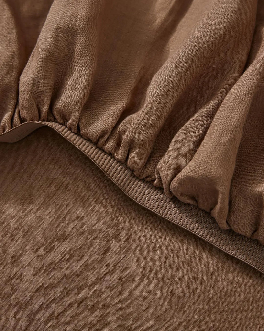Ravello Fitted Sheet in Biscuit, close-up of elastic edge and ribbed binding detail by Weave Home