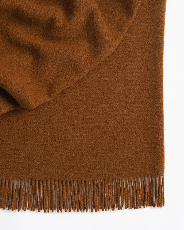 Nevis Spice throw in burnt brown lambswool with tassel fringe border detail, 130x200cm by Weave Home