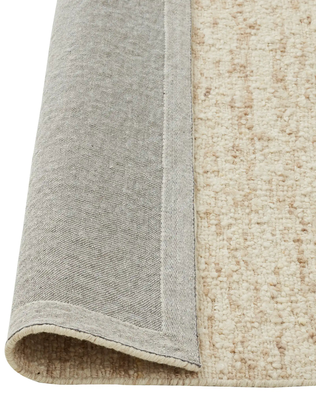 Henley Ivory rug detail showing bound edge, bouclé NZ wool weave, and backing construction by Weave Home