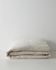 Sova Quilt Cover in Savanna pinstripe, folded flat to show soft European linen texture and neutral tone by Weave Home