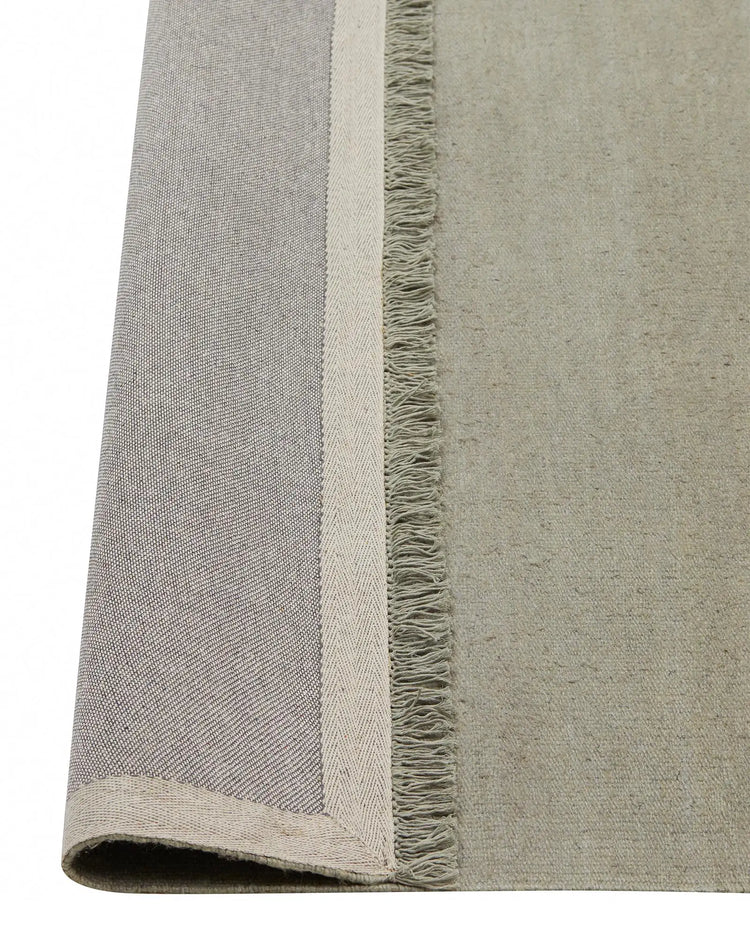 Emilio Flint linen rug detail showing flat-weave texture and fringe border edge by Weave Home