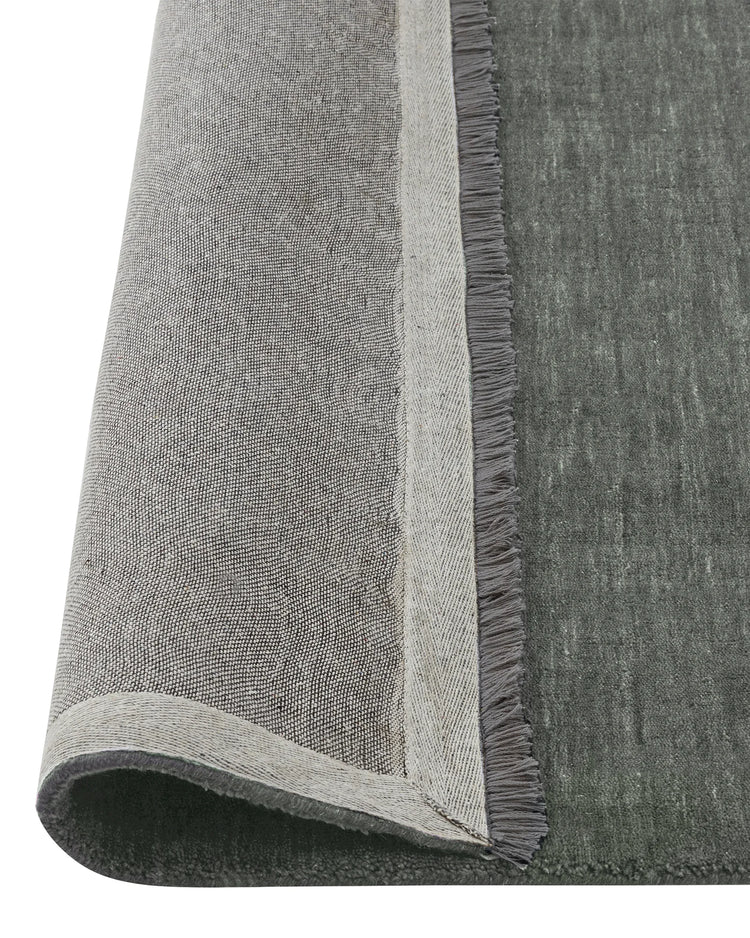 Silvio Fog rug detail view, deep grey with blue undertones, showing micro fringe border and textured weave by Weave Home